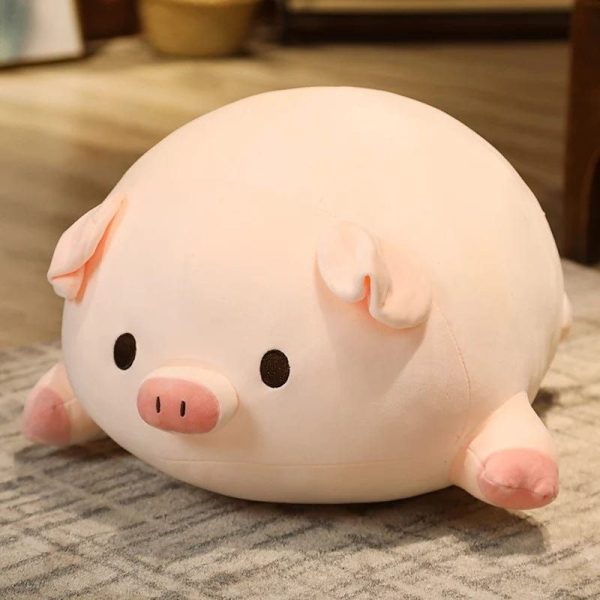 peluche cochon allongé aux yeux ouverts