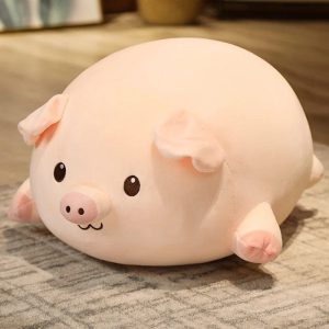 peluche cochon allongé content